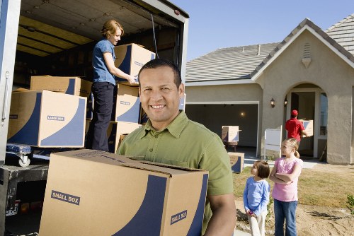 Experienced movers unpacking items in a new home